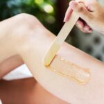 Woman getting legs waxed at a spa